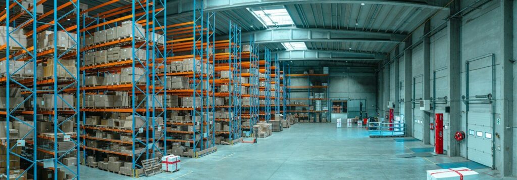 Warehouse aisle with blue shelving and cardboard boxes